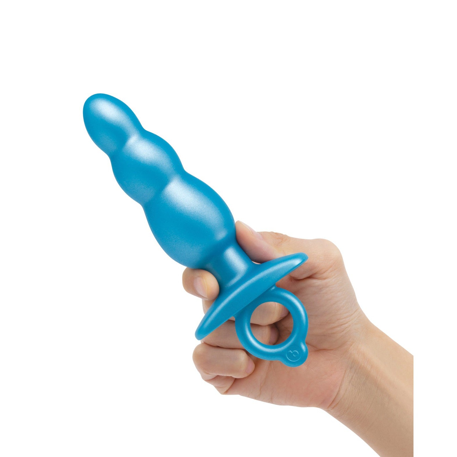 A hand holds the b-Vibe Butties Bounce Beaded Tapered Plug, a blue, rubber-textured item with a ring handle, against a plain white background.