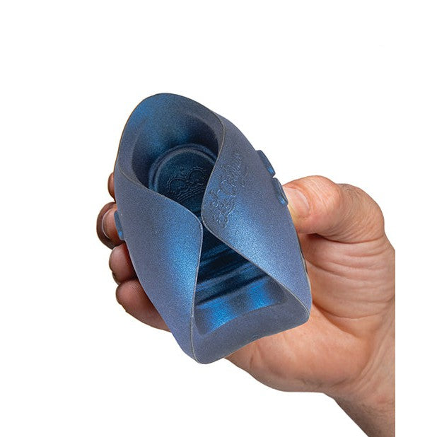 A hand holds a flexible, blue, oval-shaped object with a textured surface reminiscent of the Hot Octopuss Pulse Dragon Eye 10th Anniversary Limited Editions innovative design.