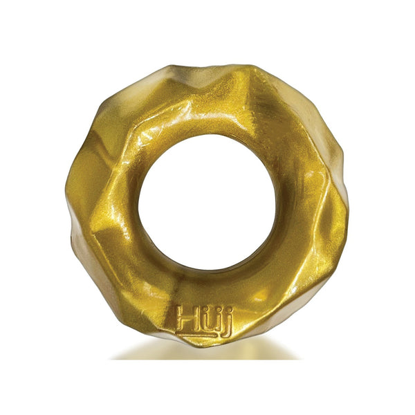 A golden, metallic donut-shaped ring with a wavy edge and central hole, made of Plus+SILICONE and embossed with Hรผj, reflecting Hunky Junks design style. This is the Hunky Junk Fractal Cockring by Hunky Junk.