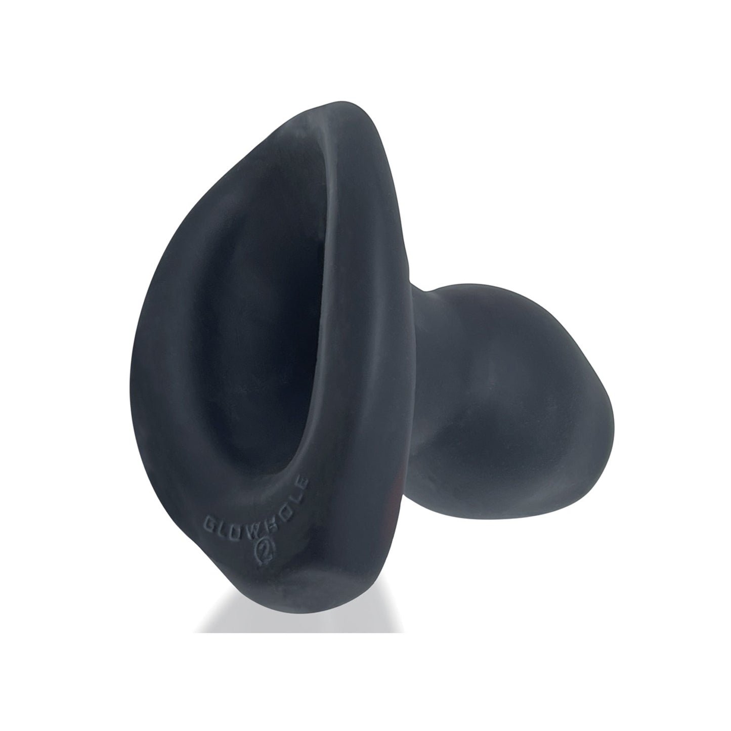 The Oxballs Morphhole 2 Gaper Plug, in black silicone with a round base and deep curved cavity, features the word GLOWHOLE on its sleek surface. Set against a white background, the modern design by Oxballs captures intrigue.