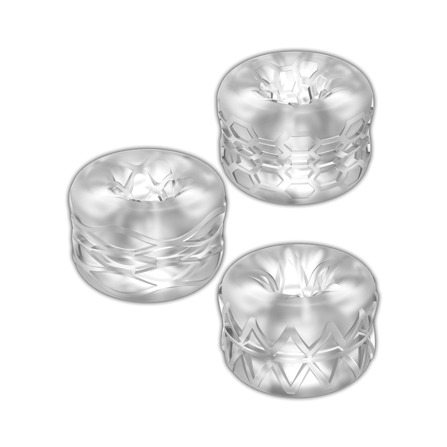 The Zolo Bumperz Squeezable Stroker Set, featuring three transparent glass rings with intricate textures of hexagons, diamonds, and grid-like patterns, is displayed against a white background, showcasing their crystal-clear and reflective surfaces.