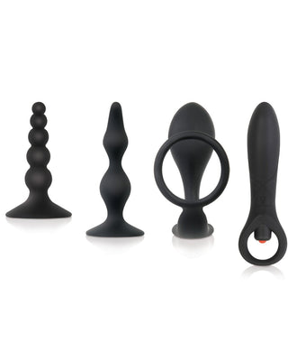 The Zero Tolerance Intro To Prostate Kit, featuring four black silicone P-spot toys of different shapes and sizes, including one with a loop handle, is elegantly displayed in a row against a white background.