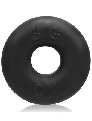 A black, circular Oxballs Big Ox Cockring by Oxballs features a smooth texture and BIG OX embossed on its glossy surface, casting a subtle shadow on the white background.