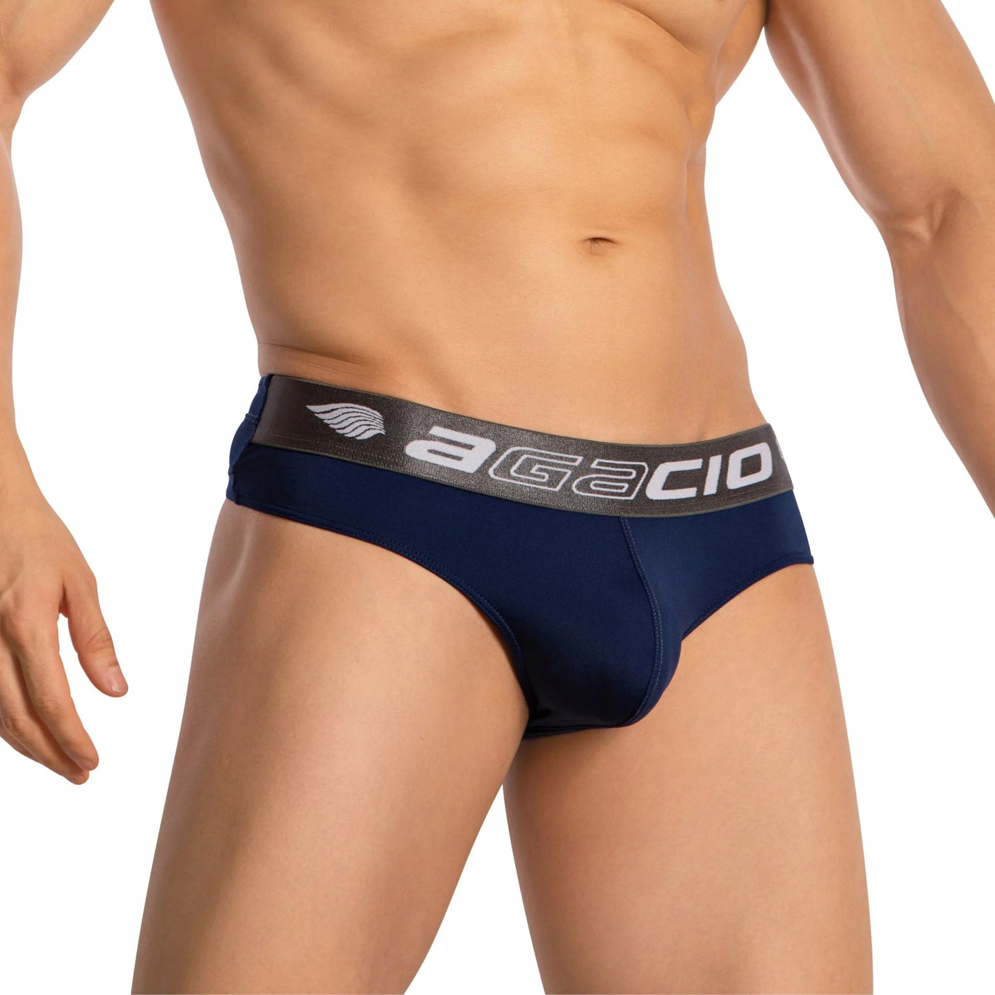 Someone wearing Agacio Thongs for Guys Sports Underwear in dark blue with a black Agacio-branded waistband, featuring a sleek sporty design with a supportive contour pouch, highlights the torso and hips against a white background.