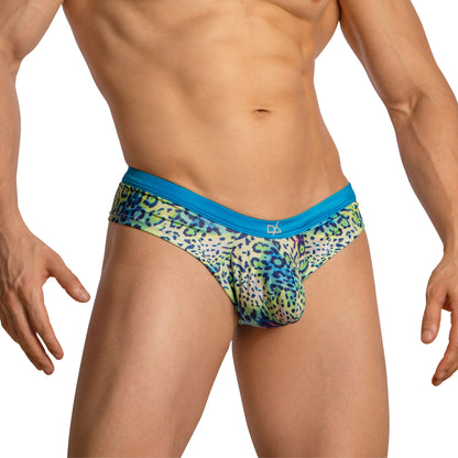 A person models the Daniel Alexander Boxer Briefs with Leopard Print against a white background, highlighting the vibrant pattern and blue waistband. The body-hugging fit and stretchy fabric are showcased, focusing on the torso and legs.