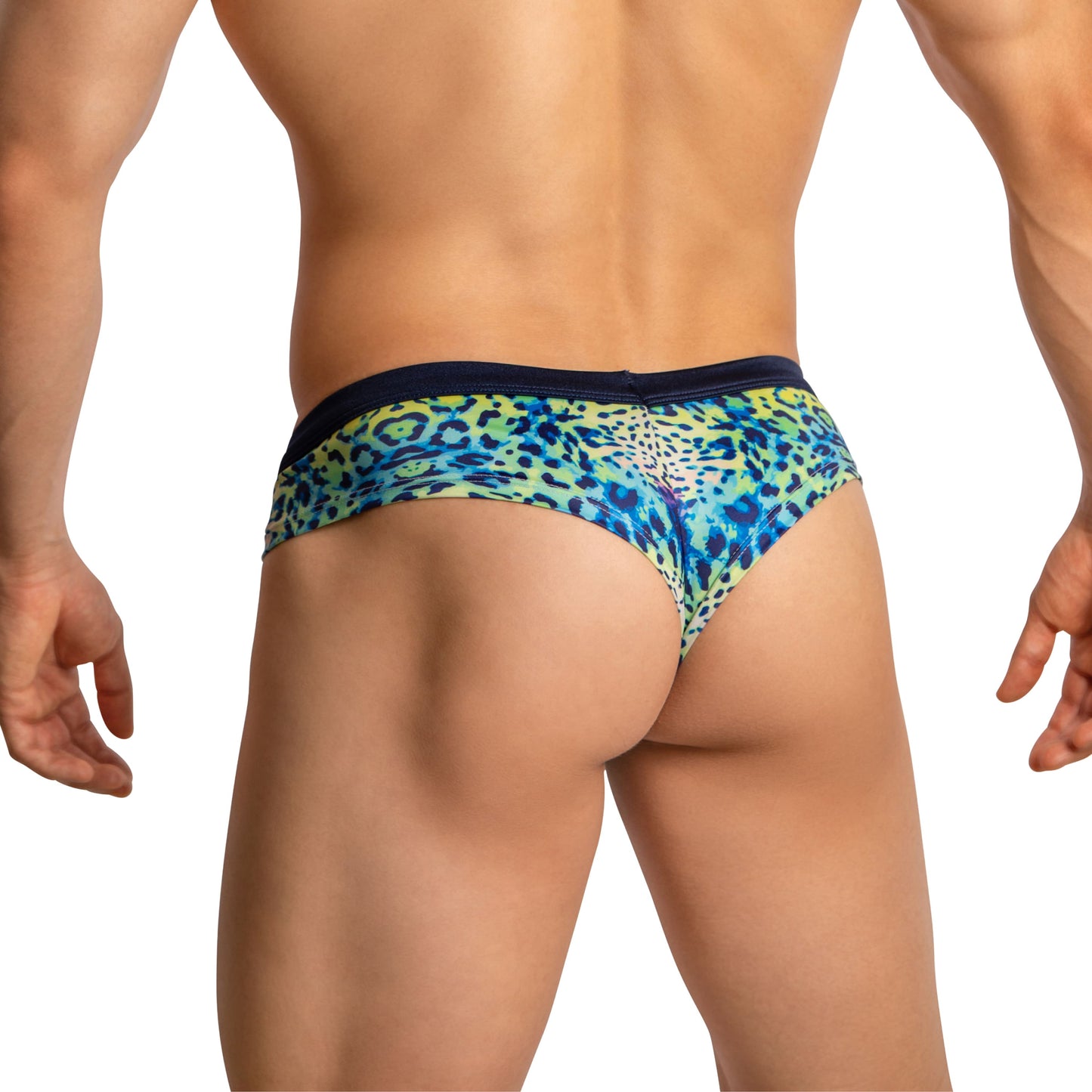 A person models Daniel Alexander Boxer Briefs with Leopard Print, showcasing a blue, green, and yellow design. The stretchy fabric and body-hugging fit let their hands rest naturally by their sides while they stand back towards the camera.