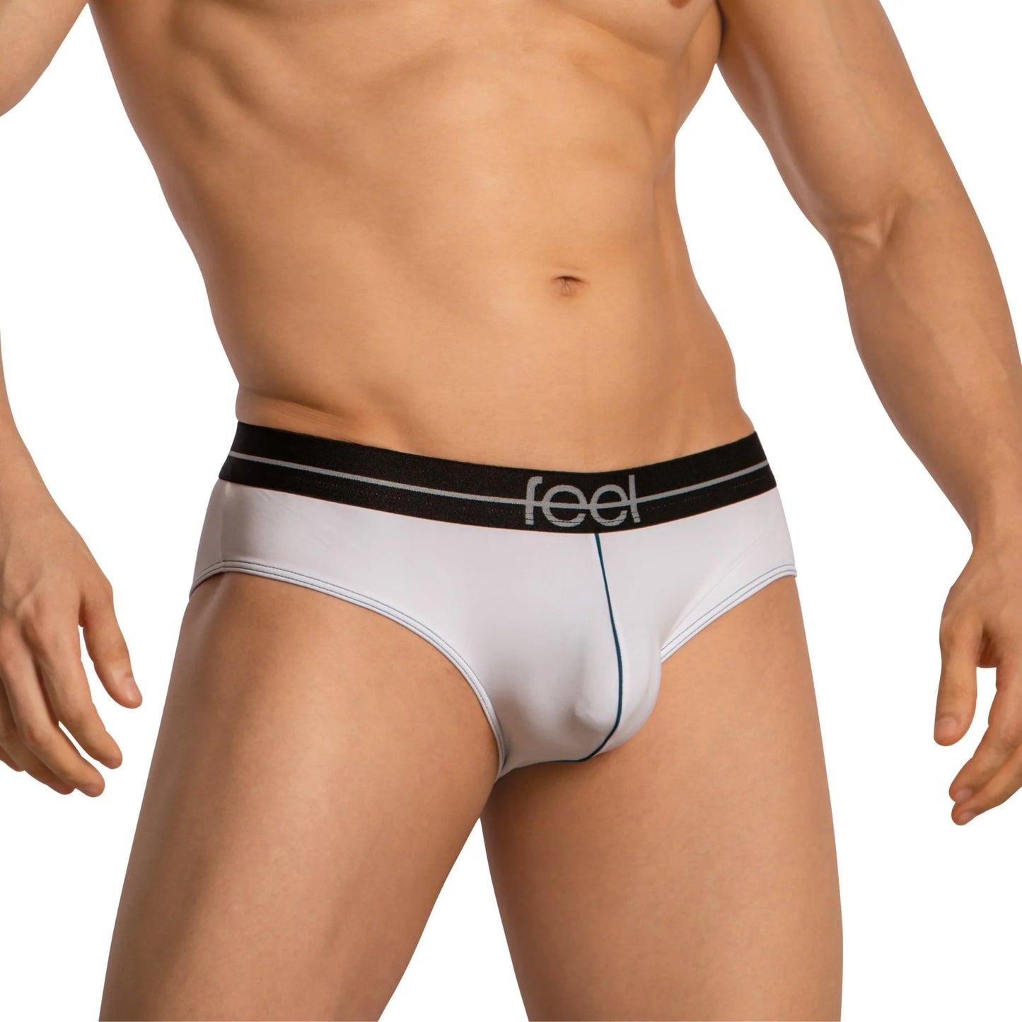 A person stands against a plain background, wearing Feels luxurious Feel Thongs for Men. The design highlights the midsection with a contour pouch and features a black waistband with Feel branding for added comfort.