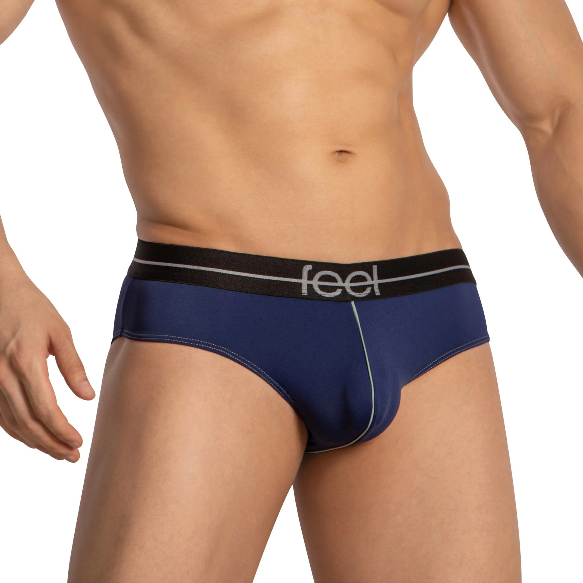 A muscular person is modeling Feel Thongs for Men, navy blue with a black waistband displaying Feel in gray. The image highlights the luxurious fabric blend, snug fit, and contour pouch for a perfect blend of style and comfort.