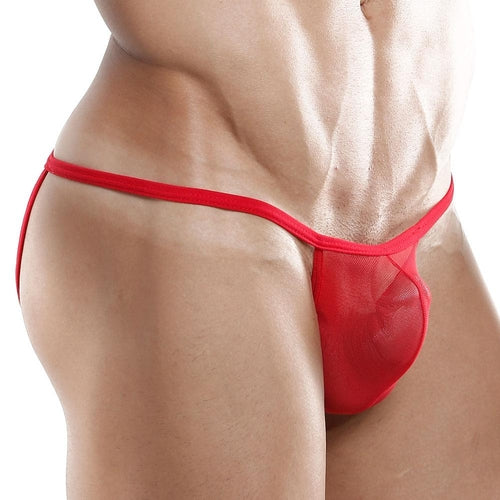 A person models the Good Devil Jockstrap, highlighting muscular abs and hips under its low-waist, red sheer thong design with a see-through pouch against a bold, minimalist white backdrop.