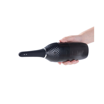 A hand holds the black Auto Bulb Auto Spray Enema by Honey Play Box, elegantly designed with a textured grip and sleek, elongated shape. Its subtle surface pattern offers a modern, stylish look, perfect for efficient anal douching.