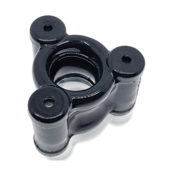 The Oxballs Heavy Squeeze Ballstretcher by Oxballs, featuring a perfectly balanced black metal design with three prongs and cylindrical extensions at the corners surrounding a central circular opening, is showcased on a plain white background.