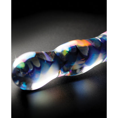 The Pipedream Icicles No. 8 Hand Blown Glass Massager features a smooth, contoured design with an iridescent, multicolored finish. Resting on a black surface, it reflects a vibrant spectrum of colors, making it perfect for temperature play.