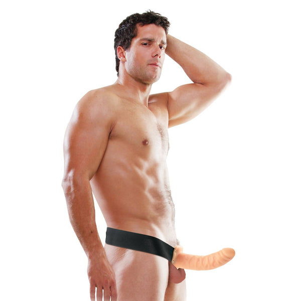 Against a white background, a man wears an elastic harness featuring the Fetish Fantasy Series 8 Hollow Strap On. Made from durable PVC by Fetish Fantasy, this lifelike extension complements his thoughtful expression as he rests his hand on his head.