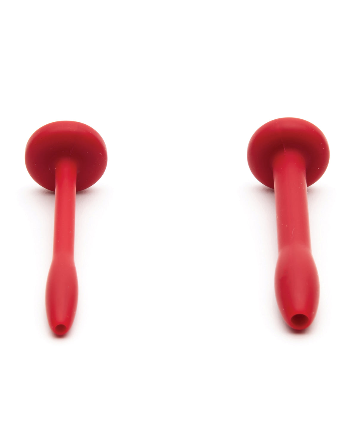 The two red silicone cum plugs from the Sport Fucker Cum Plug Kit, flat tops and tapered tips