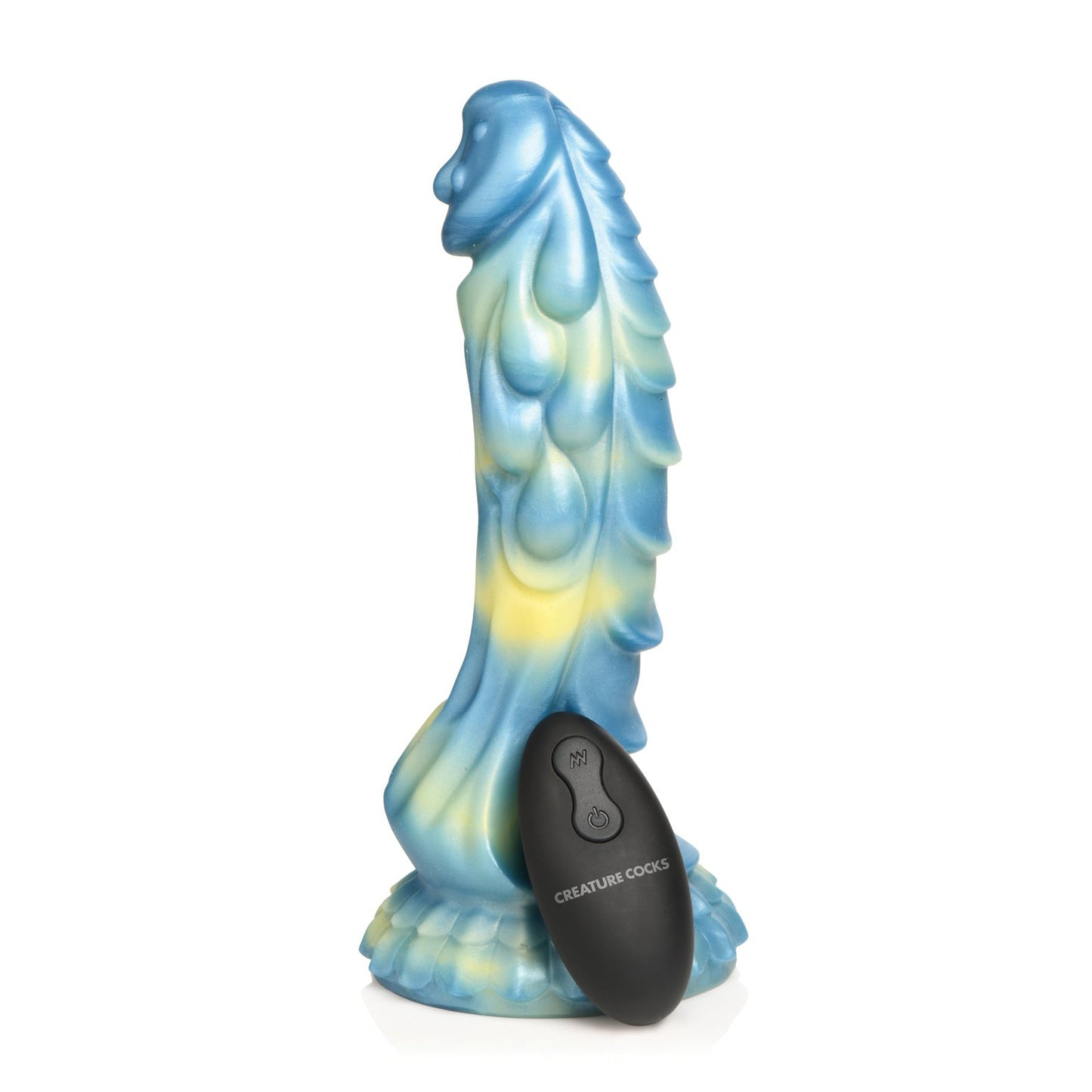 The Creature Cocks Sea Stallion Vibrating Dildo, blue and yellow with a fantasy-themed texture, stands upright. Its waterproof for adventurous play. The black remote control labeled Creature Cocks is positioned in front of it.