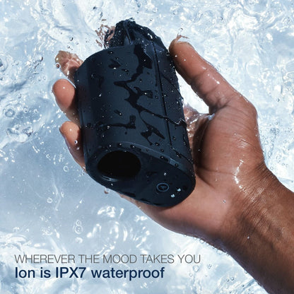 A hand grips a wet, black Arcwave Ion Pleasure Air Masturbator against a watery backdrop. The text says, Wherever the mood takes you. Arcwave Ion is IPX7 waterproof and made with CleanTech silicone for superior comfort.