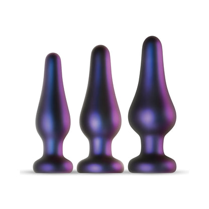 The Hueman Comets Anal Trainer Butt Plug Set by Hueman features three iridescent plug-shaped objects in varying sizes with a gradient of purple and blue hues, perfect for those exploring silicone butt plugs. Theyre elegantly displayed against a pristine white background.