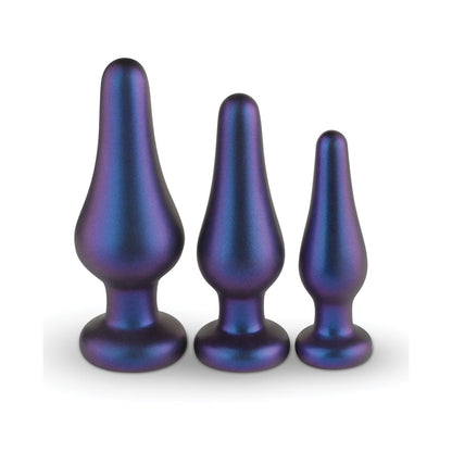 The Hueman Comets Anal Trainer Butt Plug Set by Hueman includes three iridescent, metallic plugs of varying sizes with a smooth surface and blue-purple gradient, resembling silicone butt plugs designed for comfort and style, set against a white background.