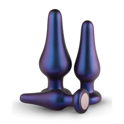 Introducing the Hueman Comets Anal Trainer Butt Plug Set: a trio in metallic blue and purple gradient, featuring varying sizes crafted from sleek silicone. Their smooth, glossy finish catches the light as they stand upright with one showcasing its flat base lying on its side.