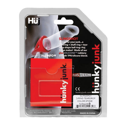 The Hunky Junk Slingshot 3 Ring Teardrop packaging showcases a vibrant red teardrop-shaped item made from smooth plus+silicone, with unique design details and a transparent window to display the product.