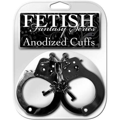 The Fetish Fantasy Series Anodized Cuffs by Fetish Fantasy are shiny black handcuffs in a stylish black and white package with decorative elements. They feature an emergency release mechanism and come with keys for enhanced control and safety.