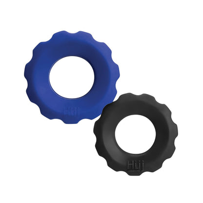 The Hunky Junk Cog Ring 2 Size Double Pack by Hunky Junk includes two round, gear-shaped objects made from TPR/silicone, one blue and one black. They feature open centers, wavy edges with Hiij embossed on them, arranged with the blue on top-left and black on bottom-right.