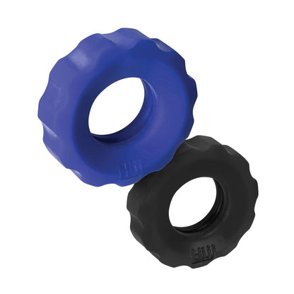 Two round dog toys, crafted with a TPR/silicone blend, available in blue and black, have wavy edges and a hole in the center. The design subtly echoes the sleek style of Hunky Junk Cog Ring 2 Size Double Pack by Hunky Junk.