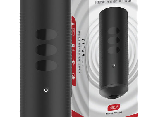 A black cylindrical electronic device, the Kiiroo Titan Interactive Vibrating Stroker, features side buttons and sits beside its ergonomically designed box. The packaging highlights smart technology under the Titan by Kiiro branding.